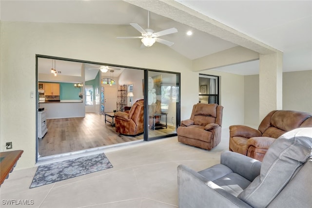 living room with lofted ceiling, light tile patterned floors, and ceiling fan