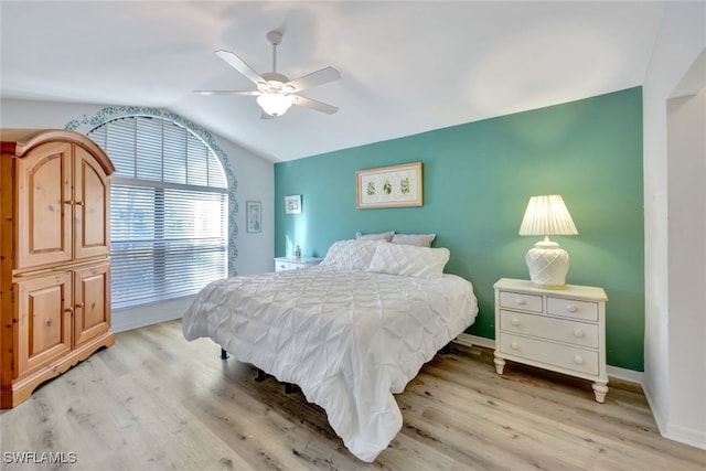 bedroom featuring vaulted ceiling, ceiling fan, and light wood-type flooring