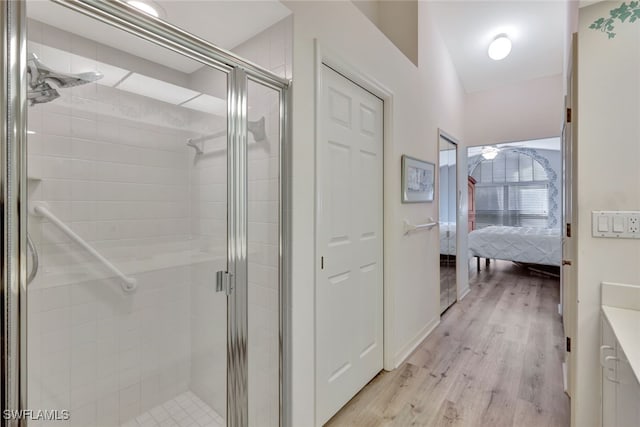 bathroom featuring hardwood / wood-style floors and a shower with door