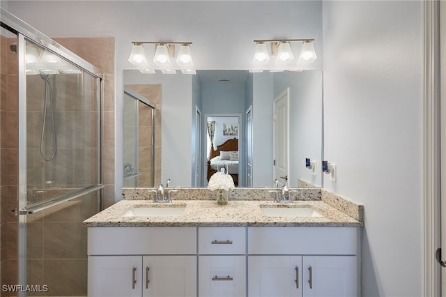 bathroom featuring vanity and an enclosed shower