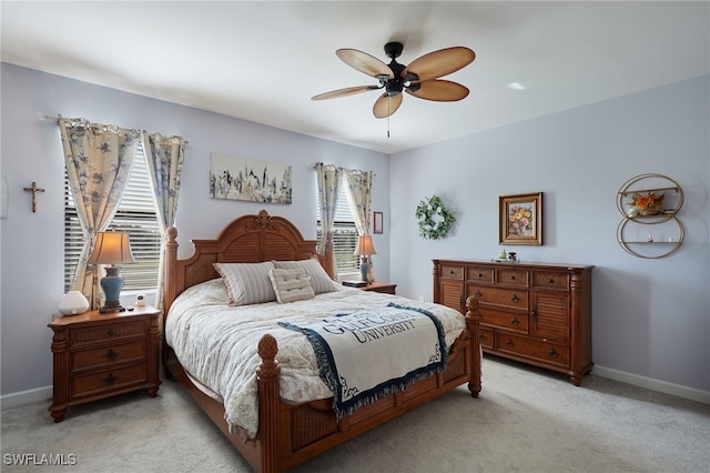 bedroom featuring light carpet and ceiling fan