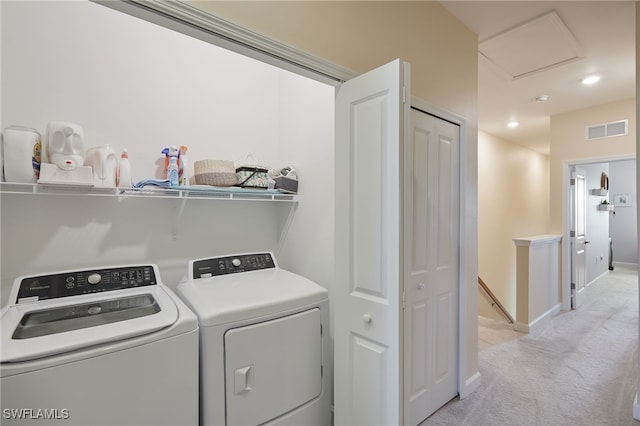 laundry area featuring independent washer and dryer and light colored carpet