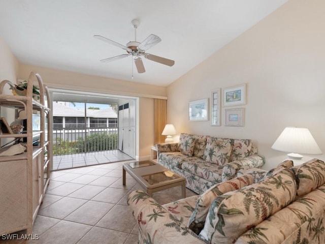 living room featuring lofted ceiling, light tile patterned floors, and ceiling fan