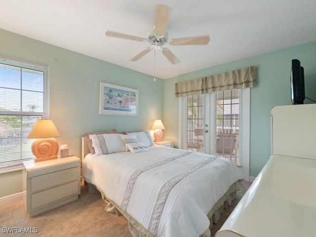 carpeted bedroom with french doors, ceiling fan, access to exterior, and multiple windows