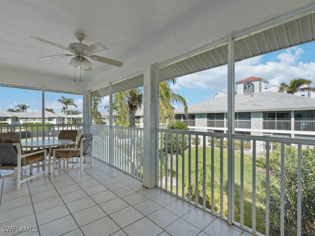 sunroom / solarium featuring ceiling fan