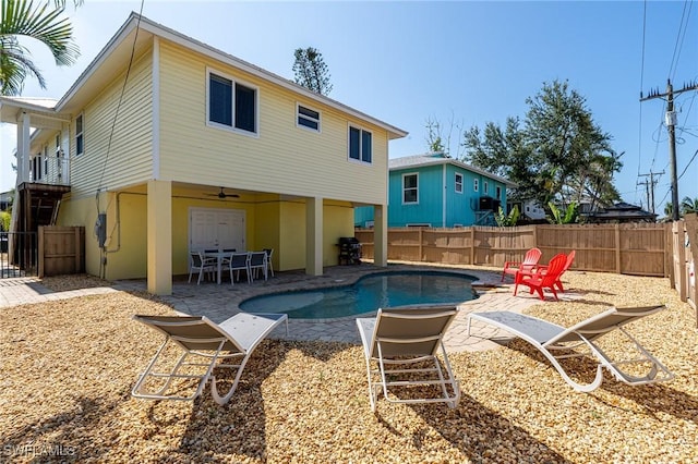 back of house with a fenced in pool, a patio, and ceiling fan