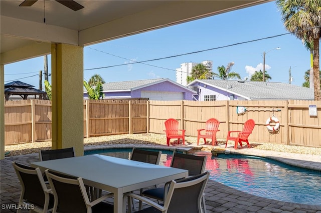 view of patio with ceiling fan and a fenced in pool