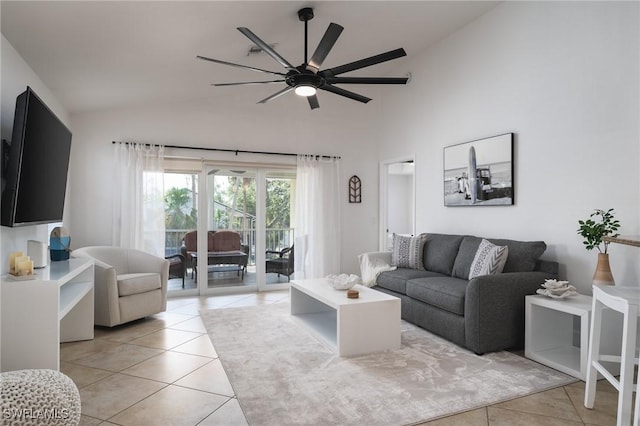 tiled living room with ceiling fan and high vaulted ceiling