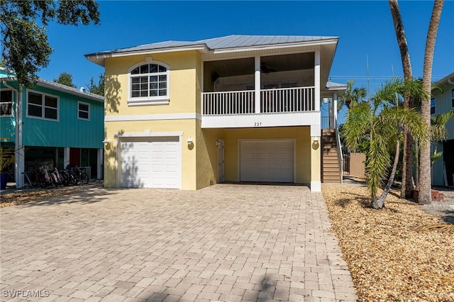 view of front of property with a garage and a balcony