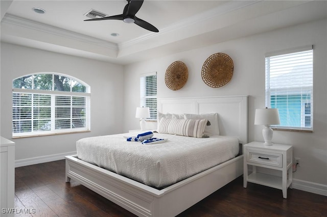 bedroom featuring a raised ceiling, crown molding, ceiling fan, and dark hardwood / wood-style flooring