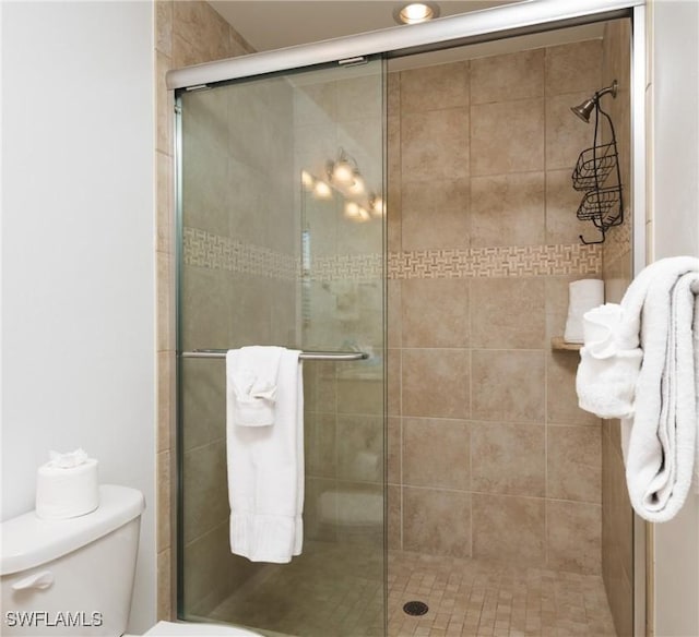 bathroom with walk in shower and toilet