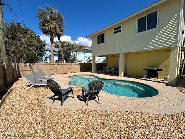 view of pool with a grill and a patio