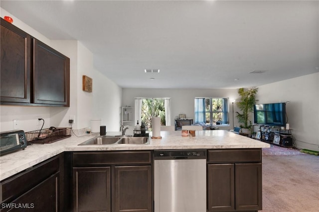 kitchen featuring dark brown cabinetry, sink, light carpet, dishwasher, and kitchen peninsula