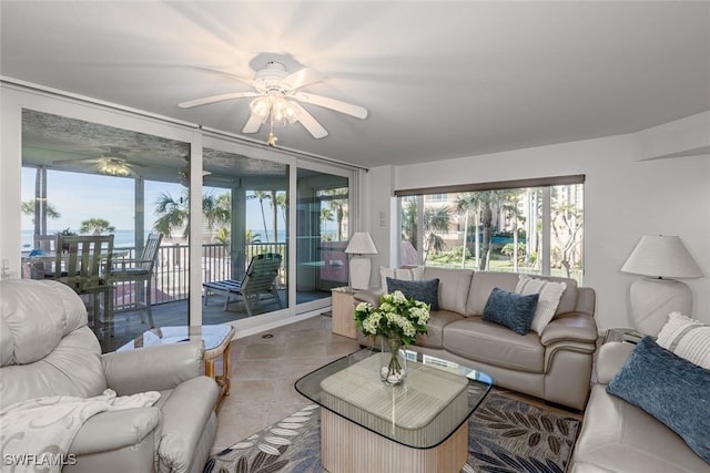 living room with ceiling fan, tile patterned floors, and a healthy amount of sunlight