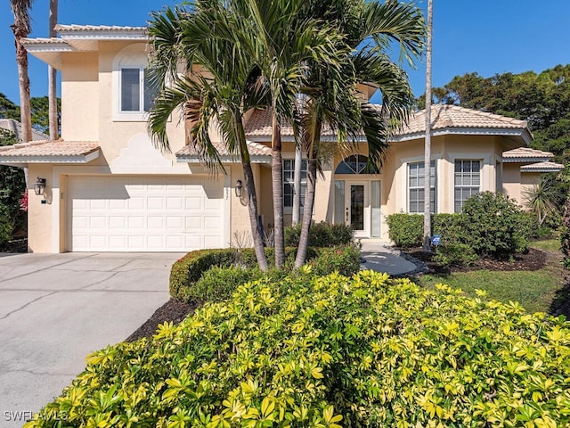 mediterranean / spanish-style house with a garage