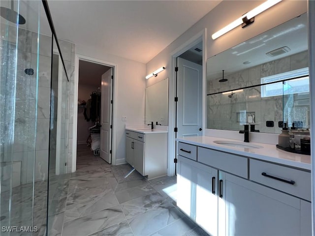 bathroom with a shower with door and vanity