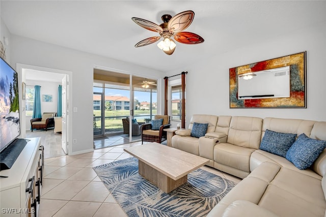 living room featuring ceiling fan, plenty of natural light, and light tile patterned floors