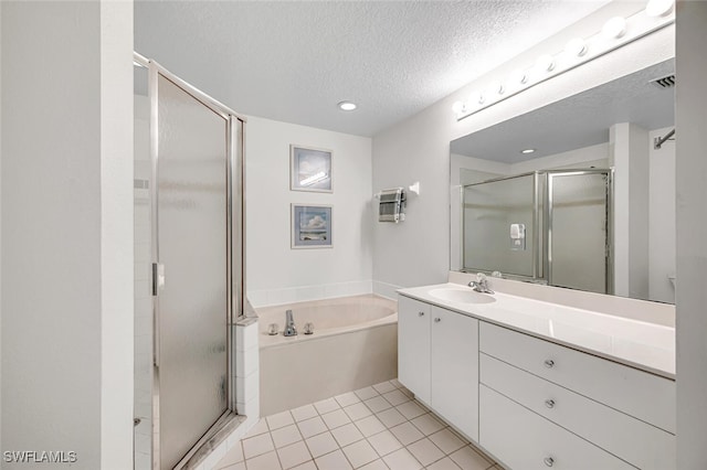 bathroom with shower with separate bathtub, tile patterned floors, a textured ceiling, and vanity