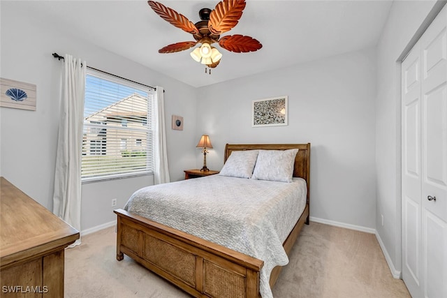 carpeted bedroom featuring a closet and ceiling fan