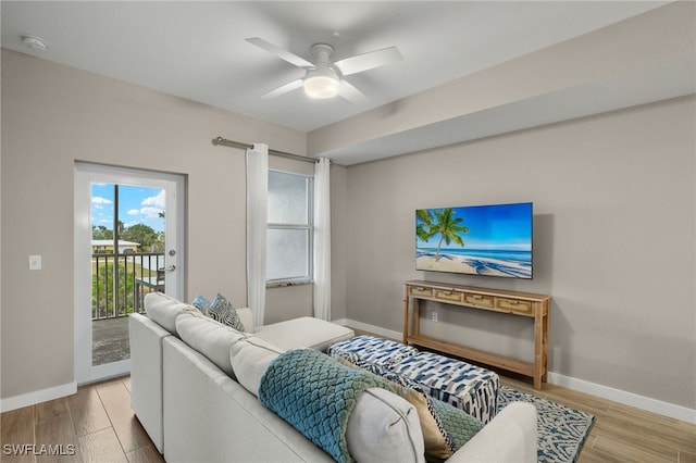 living room with hardwood / wood-style flooring and ceiling fan