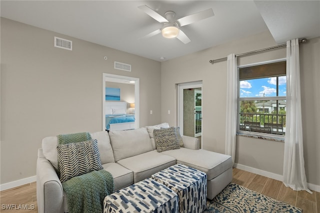 living room featuring ceiling fan and light hardwood / wood-style floors