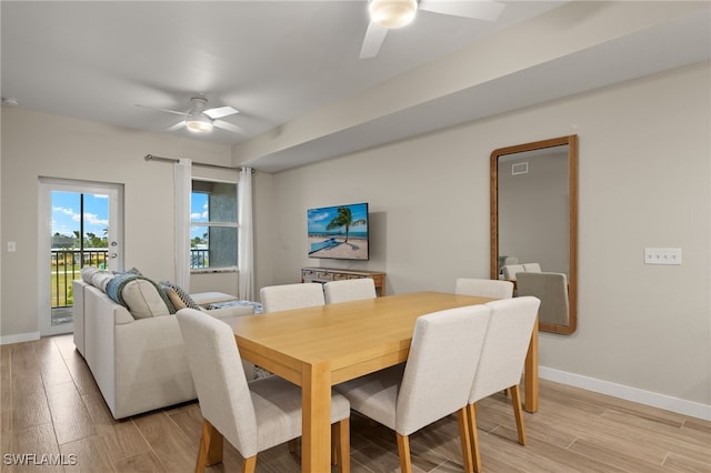 dining space with ceiling fan and light hardwood / wood-style floors