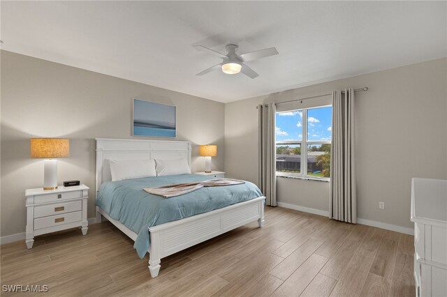 bedroom with ceiling fan and light hardwood / wood-style floors