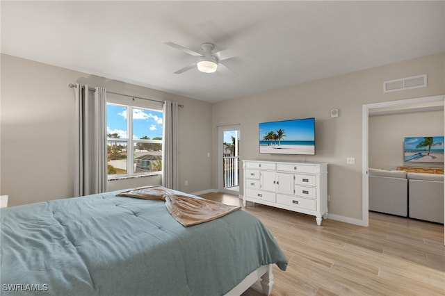 bedroom featuring access to exterior, light hardwood / wood-style floors, and ceiling fan