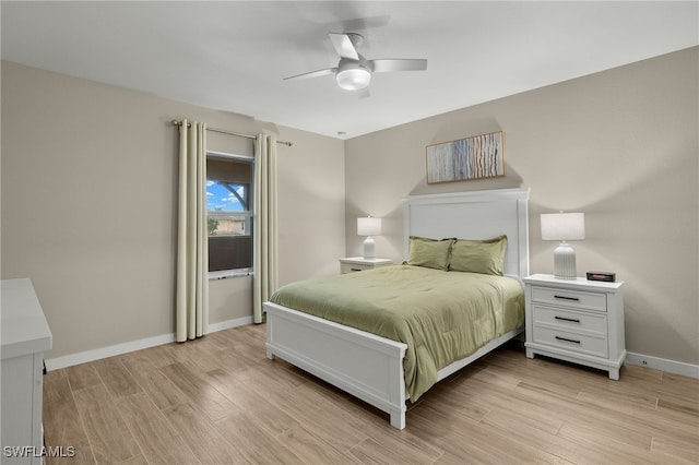 bedroom with light hardwood / wood-style floors and ceiling fan