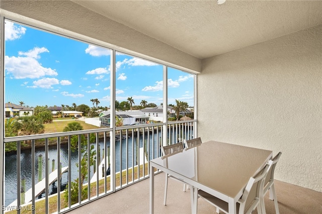 sunroom / solarium with a water view