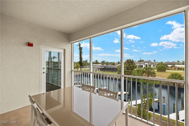 sunroom / solarium with a water view