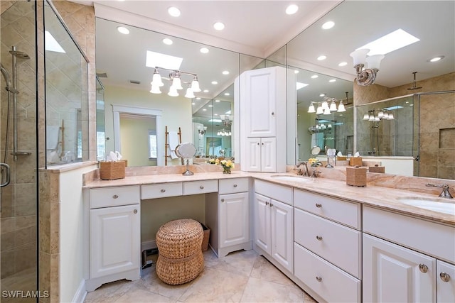 bathroom with vanity, an enclosed shower, and a skylight