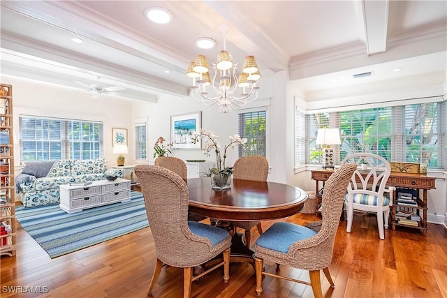 dining space featuring hardwood / wood-style flooring, a wealth of natural light, and beam ceiling