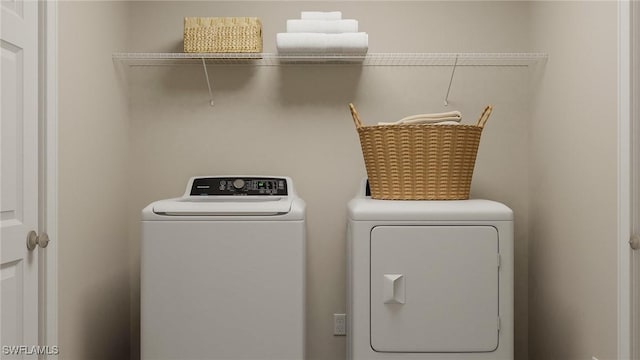 washroom with washing machine and clothes dryer