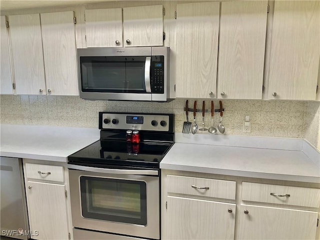 kitchen featuring decorative backsplash, stainless steel appliances, and light brown cabinets