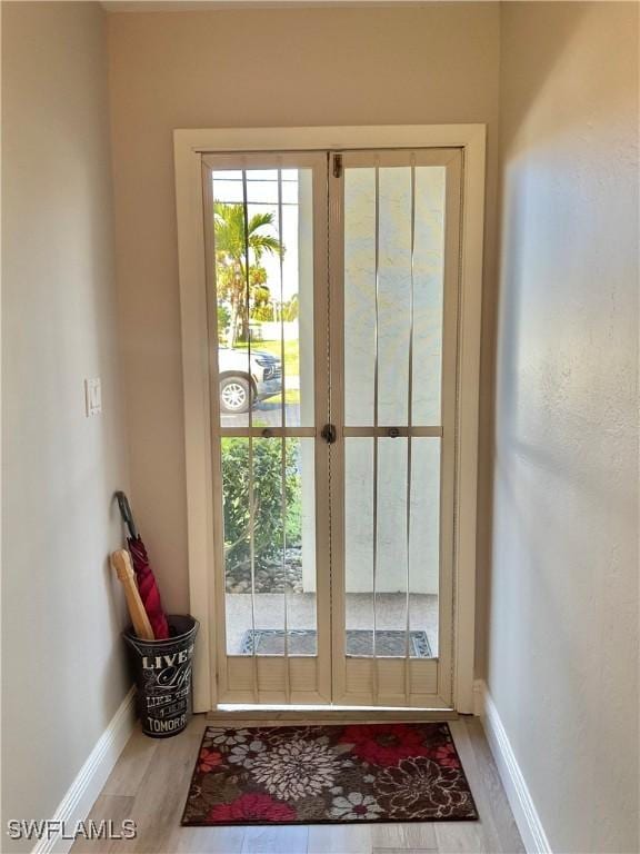 entryway with hardwood / wood-style flooring and french doors