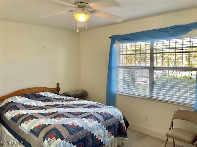 bedroom with hardwood / wood-style flooring and ceiling fan