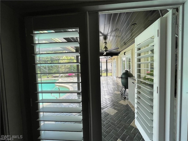 doorway to outside featuring ceiling fan