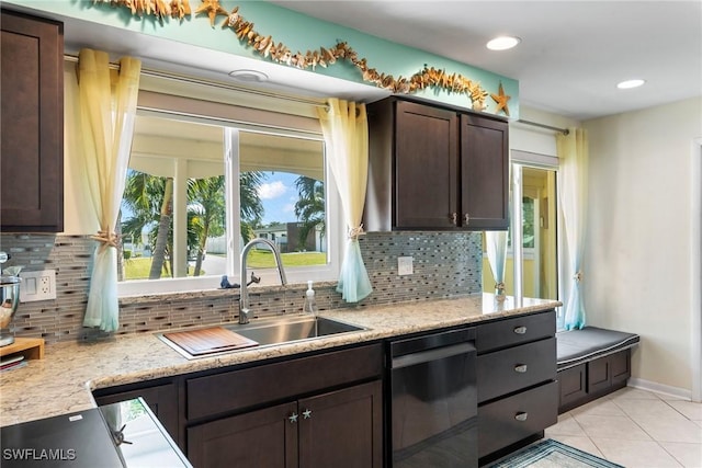 kitchen featuring sink, dark brown cabinets, light tile patterned floors, black dishwasher, and decorative backsplash