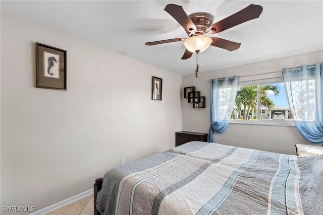 tiled bedroom featuring ceiling fan