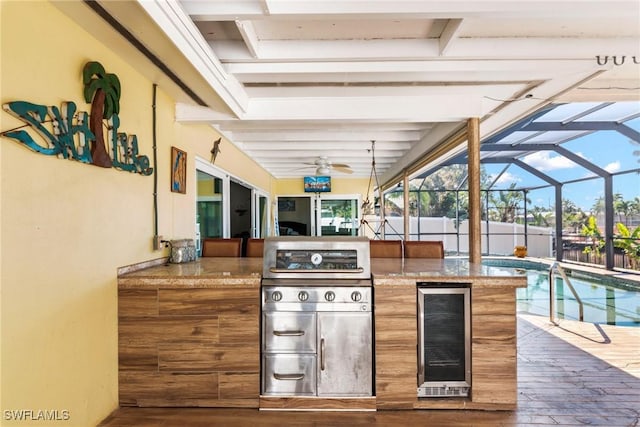 view of patio featuring a lanai, an outdoor kitchen, wine cooler, and an outdoor bar