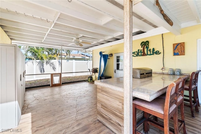 interior space with ceiling fan and beam ceiling