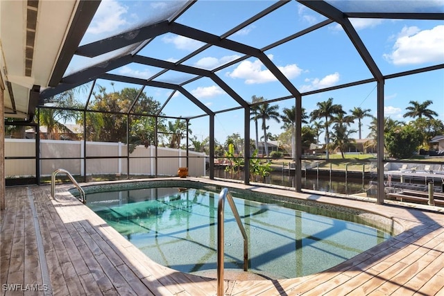 view of pool featuring glass enclosure