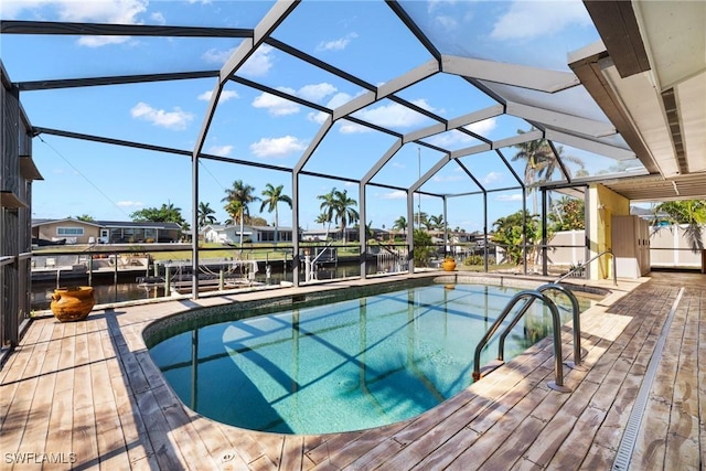 view of swimming pool featuring a water view, a lanai, and a patio area