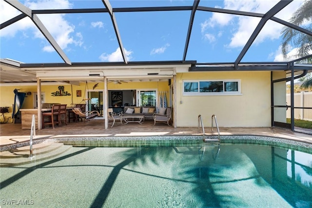 back of house with outdoor lounge area, a lanai, an outdoor bar, and a patio area