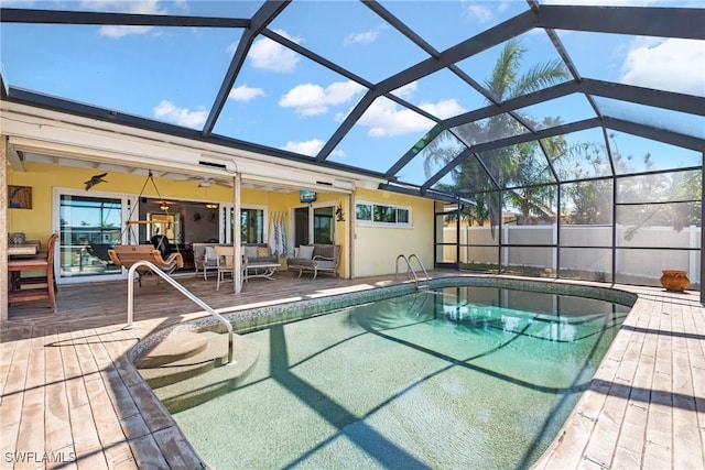 view of pool with a patio, a lanai, outdoor lounge area, and ceiling fan