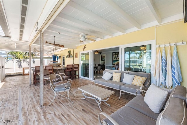 wooden deck featuring an outdoor living space and ceiling fan