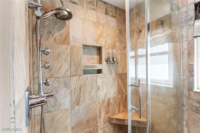 bathroom with a shower with shower door