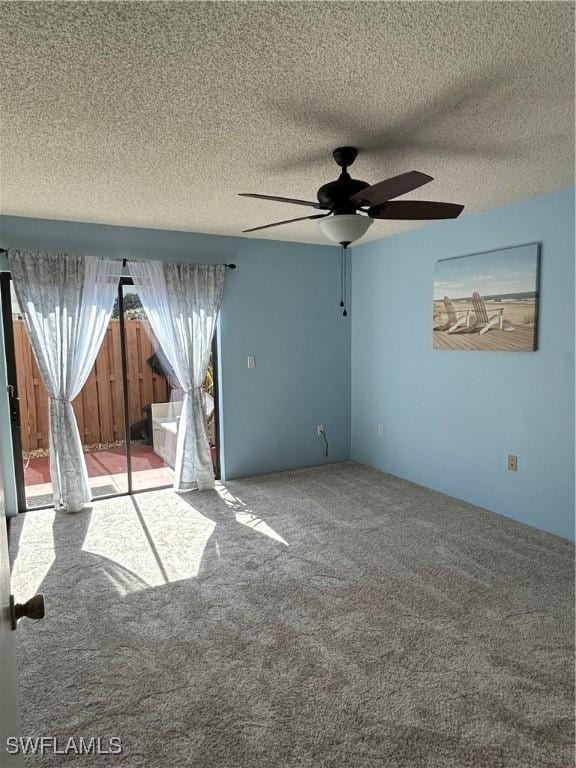 carpeted spare room featuring ceiling fan and a textured ceiling