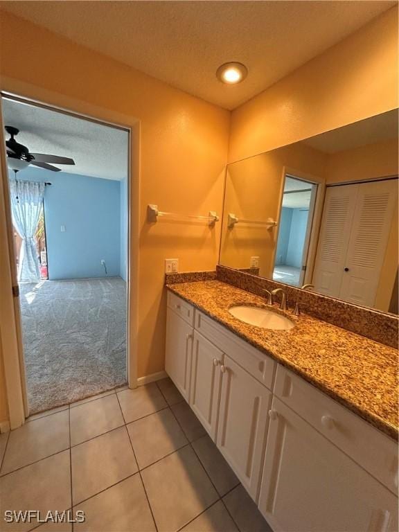 bathroom featuring vanity, a textured ceiling, tile patterned floors, and ceiling fan